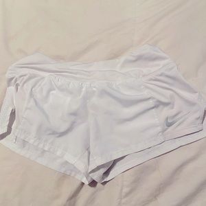 White Nike running shorts